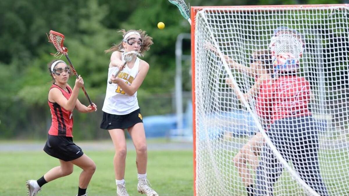 Shannon Wulff (11) of Chapel Hill scores a goal against Jacksonville's goalkeeper Kelly-lynn Schaff (24). The Chapel Hill Tigers played the Jacksonville Cardinals in Chapel Hill, N.C. on Friday, May 6, 2016. Chapel Hill won 18-4.