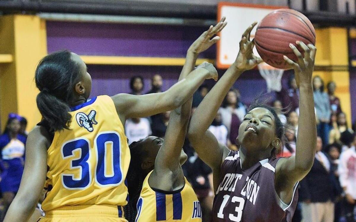 Mount Zion's Khalis Cane (13) shoots against the defense from Word of God's Zaniyah Holland (30) and Ahnasti Bridges (12). The Mount Zion Warriors took on the Word of God Holy Rams in Boys and Girls Basketball in Raleigh. N.C. on January 27, 2017. Mount Zion girls win 45-40.