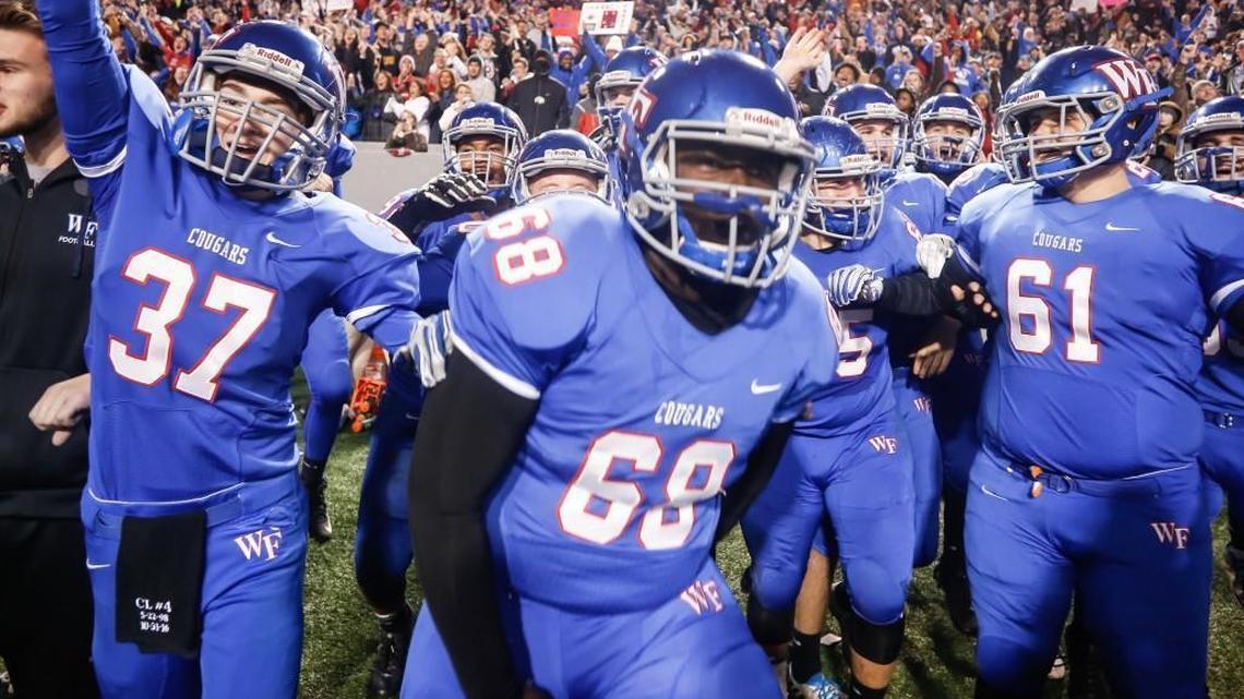 Wake Forest players Connor Sill (37), Dashawn Green (68) and Joshua Kruger (61) begin to celebrate and run onto the field as time expires in the NCHSAA 4AA football championship game between Greensboro Page and Wake Forest in Raleigh on Saturday, December 17, 2016. Wake Forest won the game 29-0.