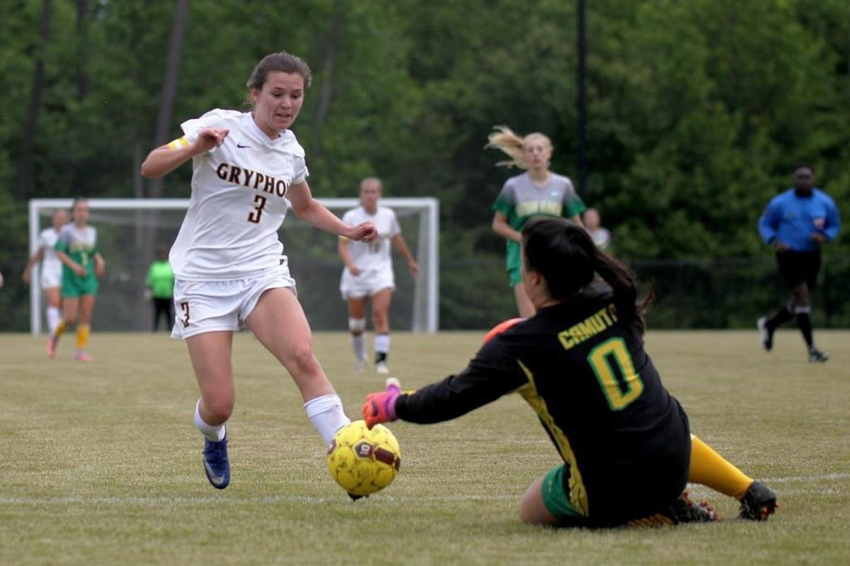 Eastern Alamance's goalkeeper Marisa Camuto (0) arrives to the ball before Rocky Mount's Sarah Bland (3) could make the shot attempt during the Eastern Alamance High School girl's soccer game against Rocky Mount High School in Rocky Mount, N.C. on Tuesday, May 9, 2017.