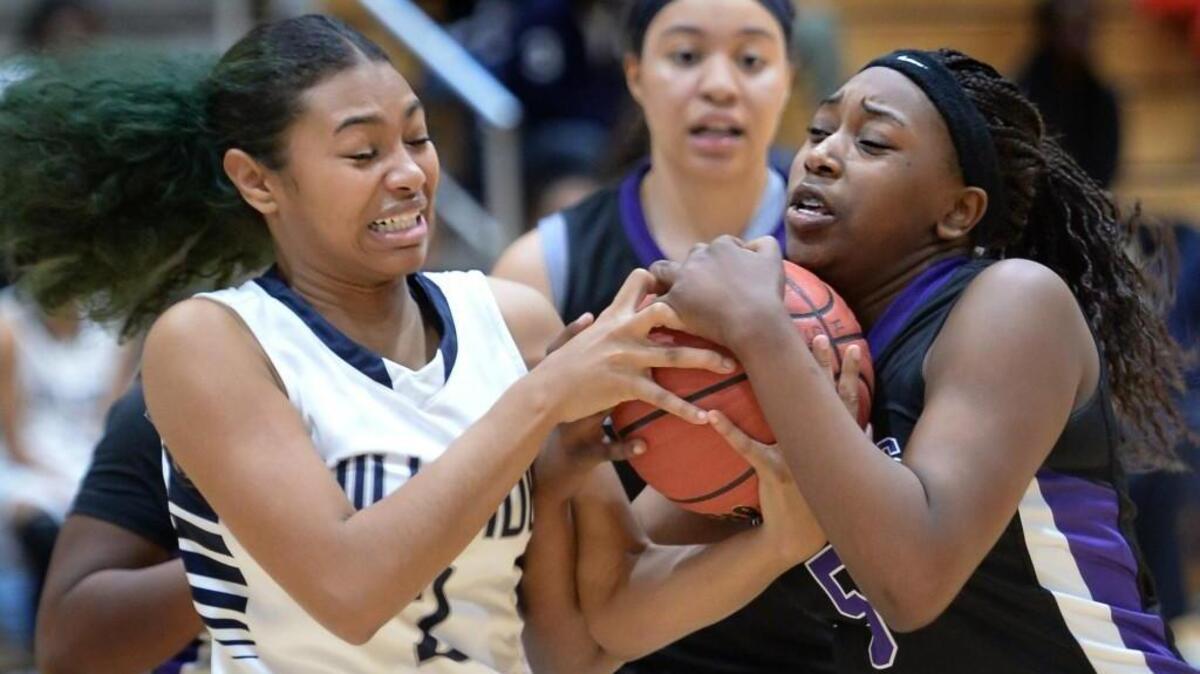 Alexis Jones (2) of Hillside and Aijah Perry (5) of Riverside fight for possession of the ball. The Hillside Hornets played the Riverside Pirates in Durham, N.C. on Friday, December 18, 2015. Hillside won 73-53.