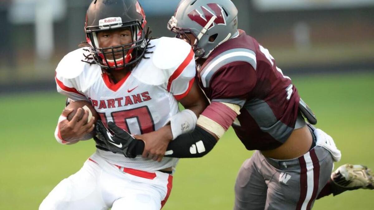 
Jordon Brown, left, of Southern is tackled by Oscar Taveras, right, of Wakefield. The Wakefield Wolverines played the Southern Spartans in Raleigh, N.C. on Friday, September 11, 2015.

