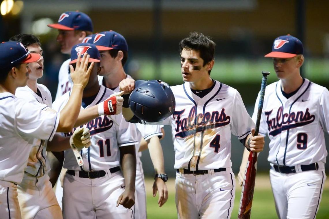 Wil Hoyle (4) of Jordan is congratulated by his teammates after scoring for the Falcons. The Jordan Falcons played the East Chapel Hill Wildcats in a baseball game that took place in Durham, N.C. on Friday, April 15, 2016. Jordan won 4-1.
