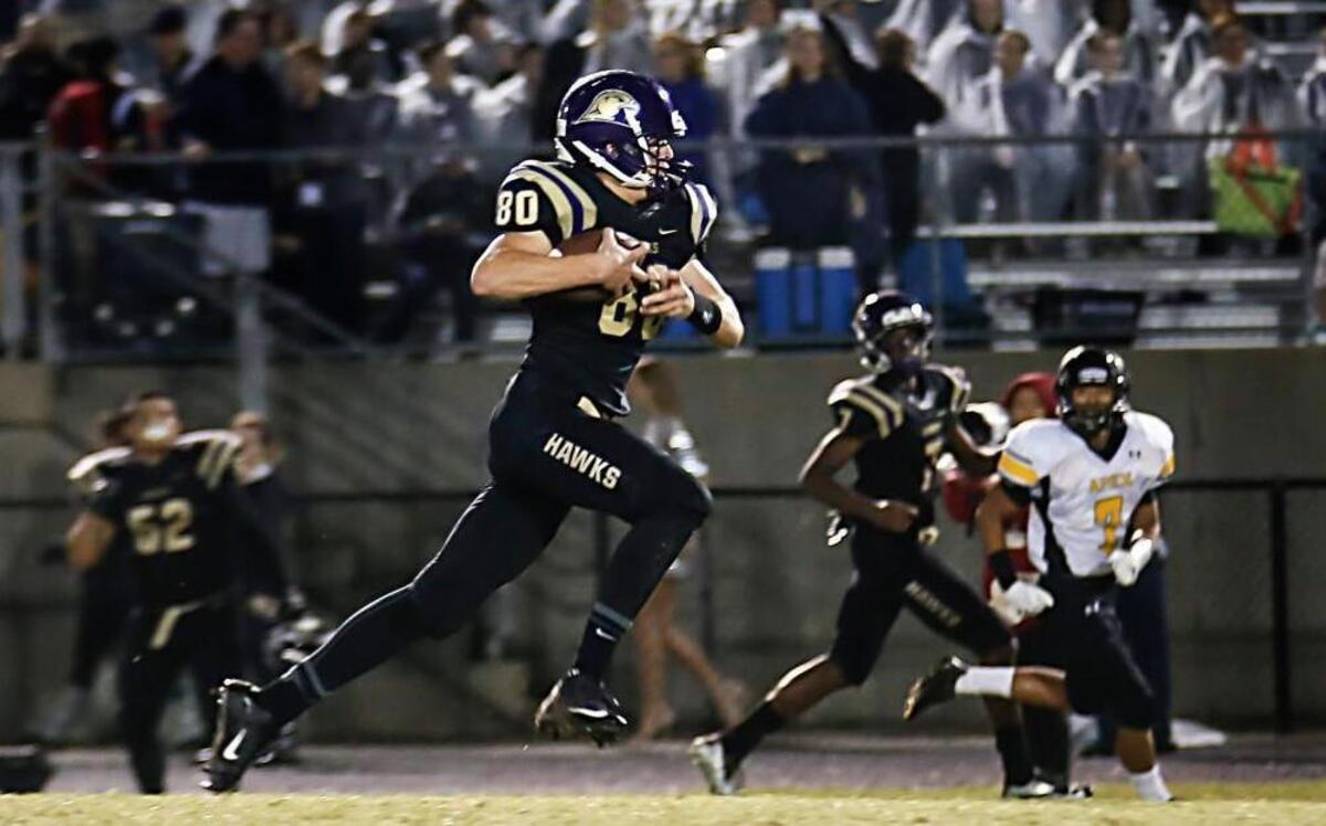 
Holly Springs tight end Alex Luedeke (80) takes a pass for a long touchdown during Apex's football game at Holly Springs on Friday, September 25, 2015. Holly Springs won 28-14.
