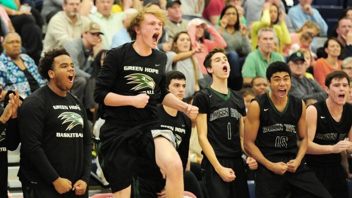 The Green Hope bench erupts as they solidify their lead over Cary during the NCHSAA SWAC Championship boys basketball game, which was played in Apex on Friday, February 17, 2017. Green Hope won 72-61.