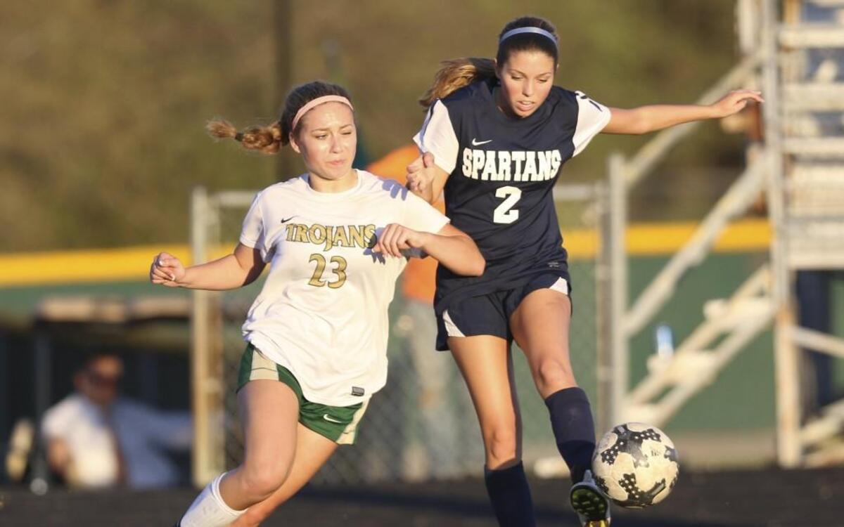 Smithfield-Selma's Mollie Lane (2) flicks the ball away from South Johnston's Alexis Davis (23). Coverage from the prep girls soccer game between the Smithfield-Selma Spartans and the South Johnston Trojans played in Four Oaks, N.C. on Tuesday, April 4, 2017. Smithfield-Selma defeated South Johnston 2-1.