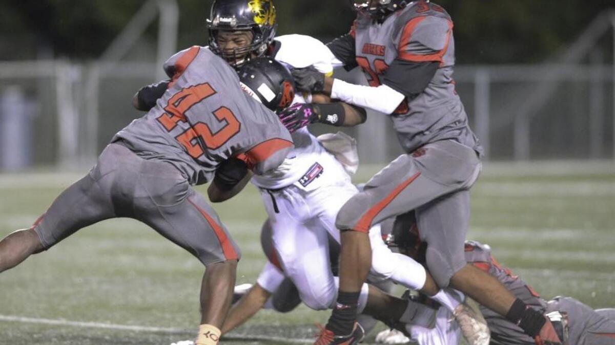Albert Nyamayaro, center, of Chapel Hill is brought down by Dominick Green, right, Taronald Beauford, second from right, and Ryan Bond, left, of Southern. The Southern Spartans played the Chapel Hill Tigers at the North Carolina Central University O'Kelly-Riddick Stadium in Durham, N.C. on Friday, November 13, 2015.