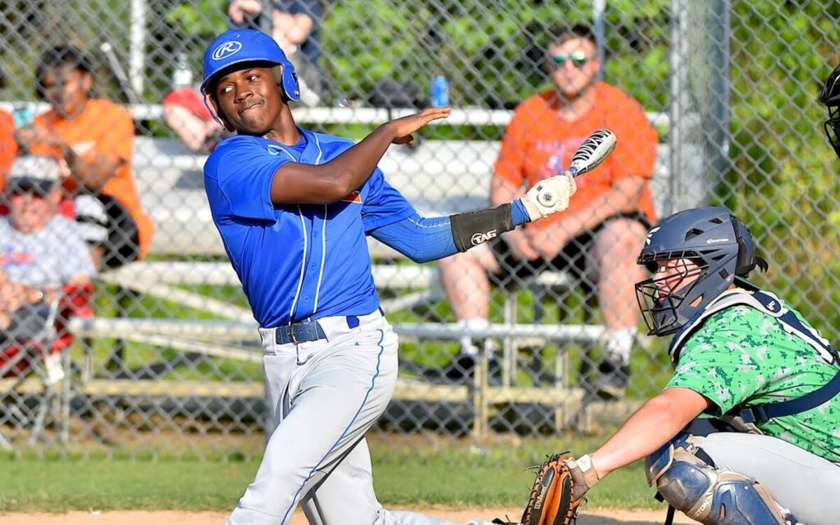 Louisburg's Quamon Person (1) follows through on his swing during the playoff game against Spring Creek. The Louisburg Warriors and the Spring Creek Gators met in the first round of the NCHSAA 1A playoffs in Louisburg, N.C. on May 10, 2017. Spring Creek wins 6-3.