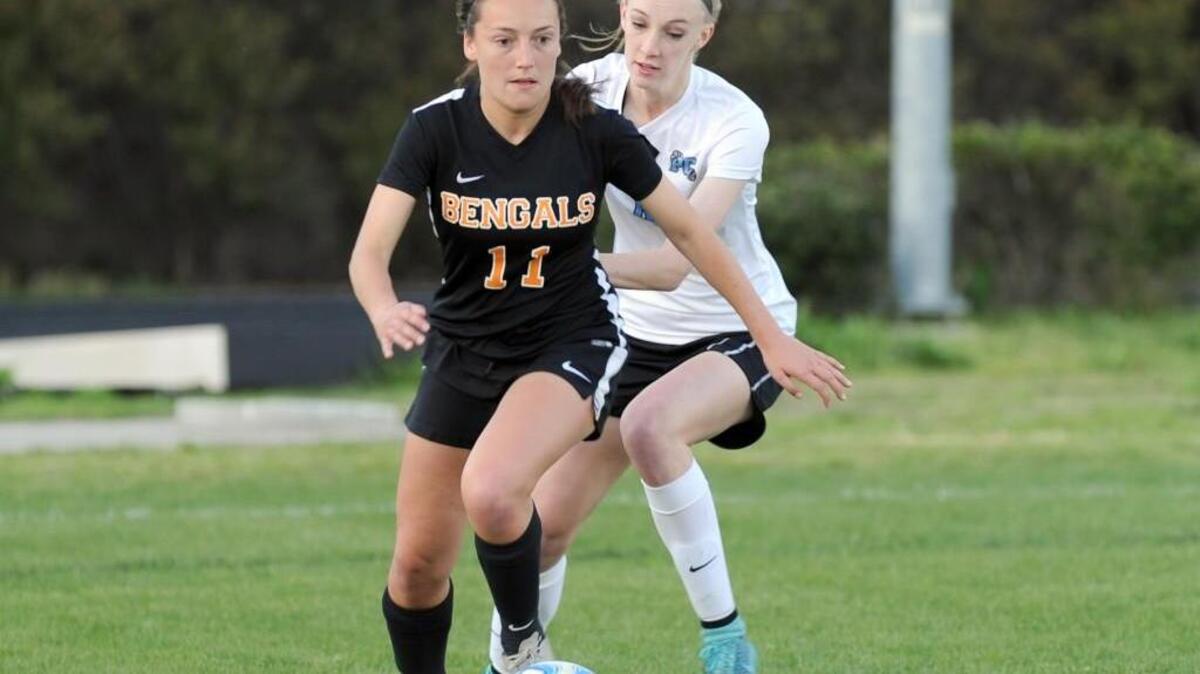 Fuquay-Varina's Kelley Suggs (11) and Panther Creek's Lauren Reichardt (right) battle for the ball during the girls soccer game, which was played in Cary on Wednesday, March 23, 2016. Fuquay-Varina won 3-1.