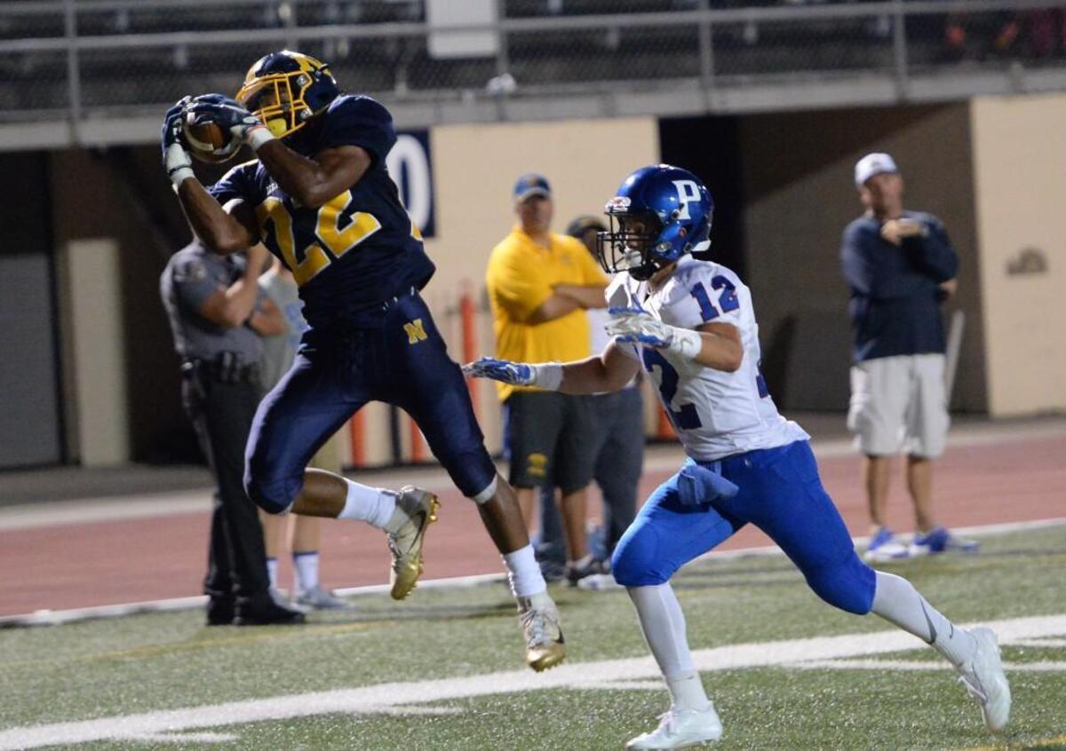 Daylan Felton (22) of Northern catches a long pass from his teammate Brycen Jackson to score a touchdown against the pursuit of Nick Jimenez (12) of Person. The Northern Knights played the Person Rockets in a football game that took place in Durham, N.C. on Friday, August 26 2017.