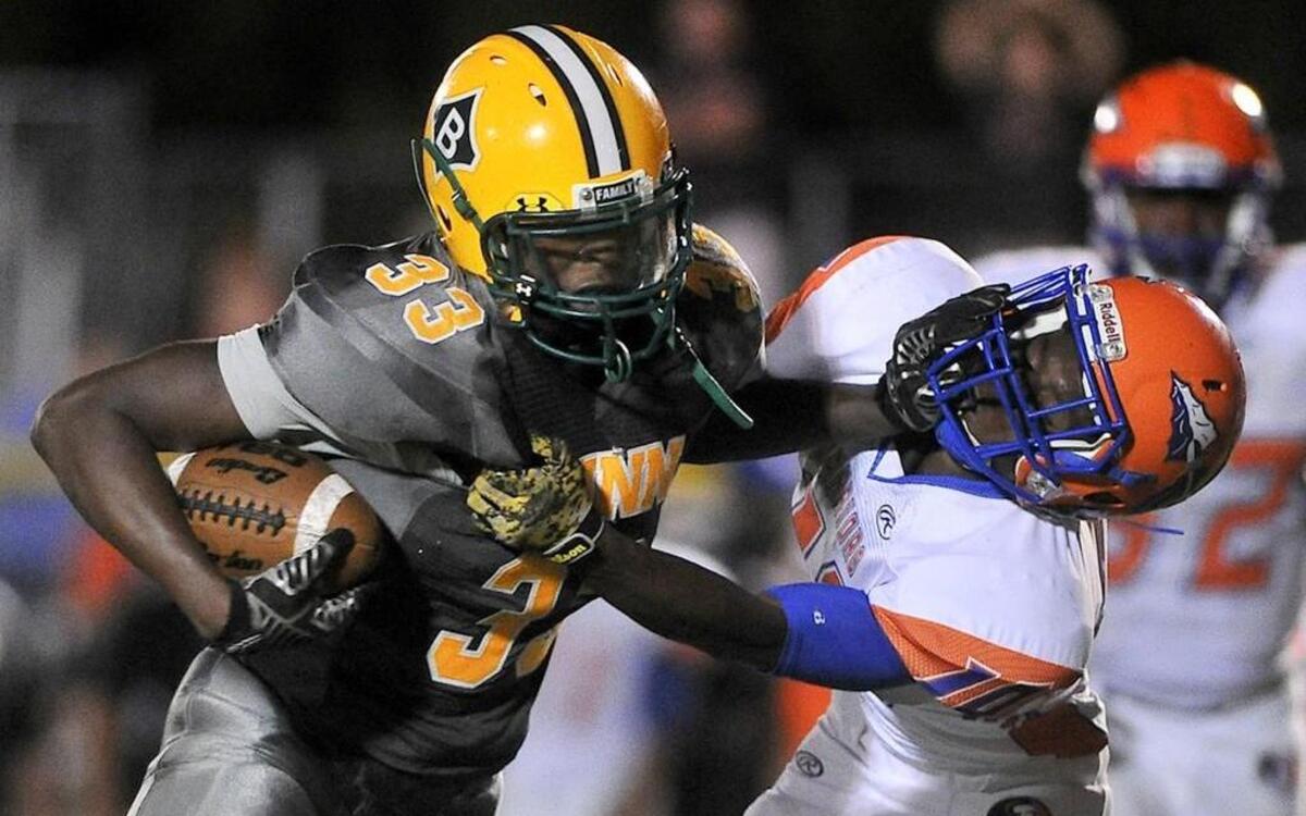 
Bunn's Celik Curtis (33) runs for yardage and stiff arms Louisburg's Tyreek Allen (10). Louisburg took on Bunn in football in Bunn, N.C. on September 18, 2015. Bunn wins 62-6.
