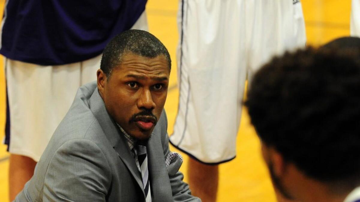 Holly Springs coach Richard Young talks to the team during the boys basketball game against Fuquay-Varina, which was played in Holly Springs Tuesday, January 26, 2016. Fuquay-Varina won 57-52.