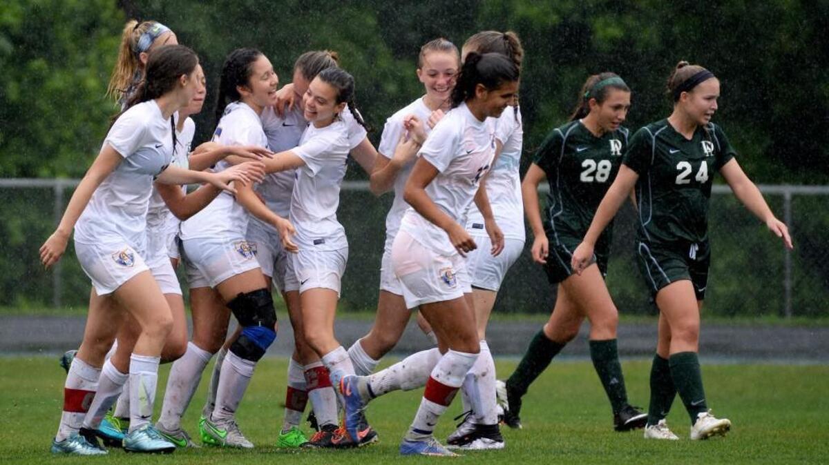 Cary Academy players celebrate as the team scores its first goal during Friday afternoon's NCISAA semifinals between Cary Academy and Durham Academy.
