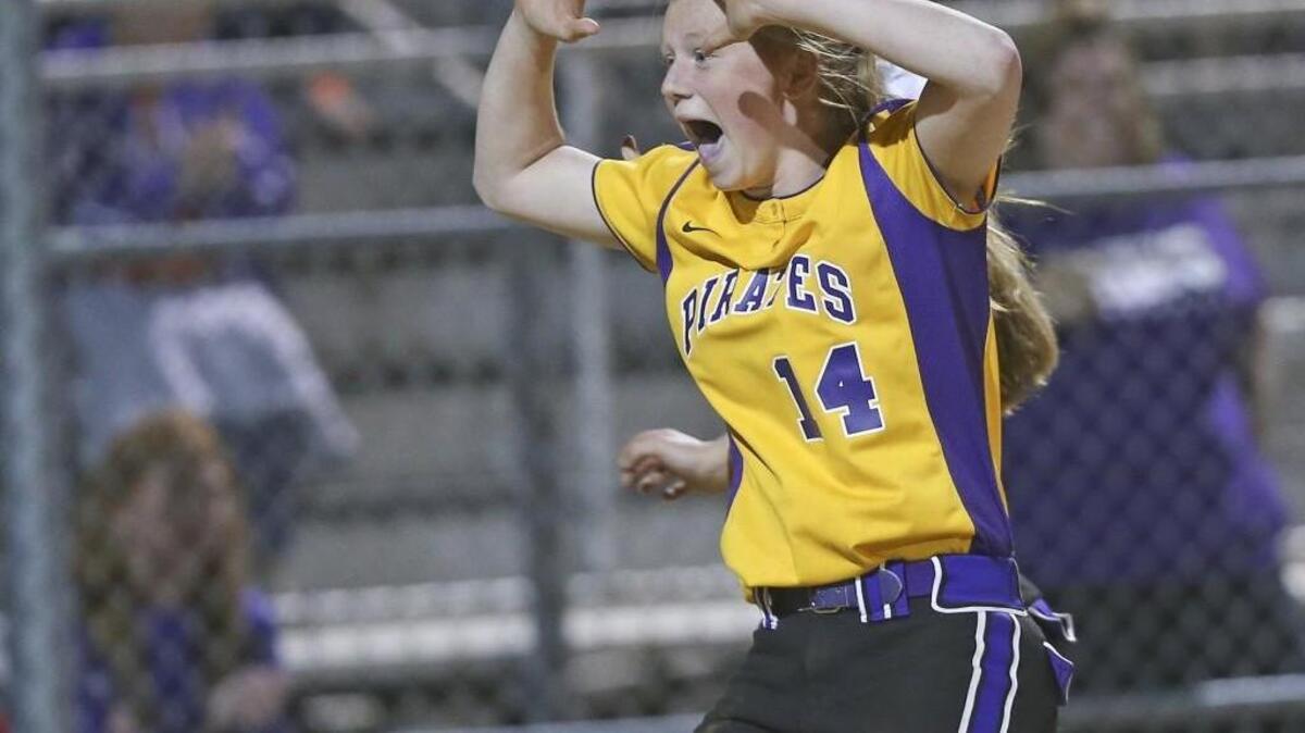 Corinth Holders' Ashlyn Biethman (14) rushes to greet teammate Kylie Keon (17) scores the winning run. Coverage of the girls prep softball game between the Corinth Holders Pirates and the South Johnston Trojans played in Archer Lodge, N.C. on Thursday, March 24, 2016. Corinth Holders defeated South Johnston 7-6 in 8 innings.