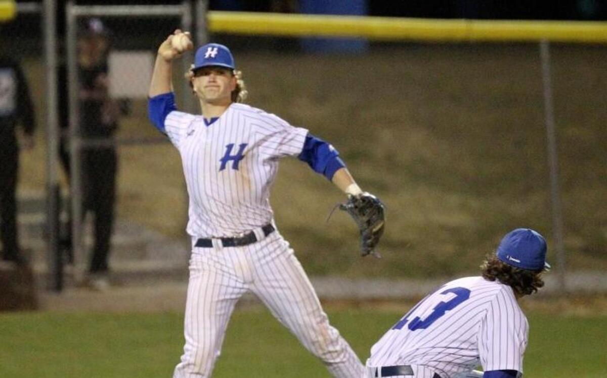 Hunt third baseman Thomas Helms (10) fields the butt and makes the throw to first over Hunt's pitcher Neal Lewis (13) during the North Johnston High School boy's baseball game against Hunt High School in Wilson, N.C. on Monday, March 6, 2017.