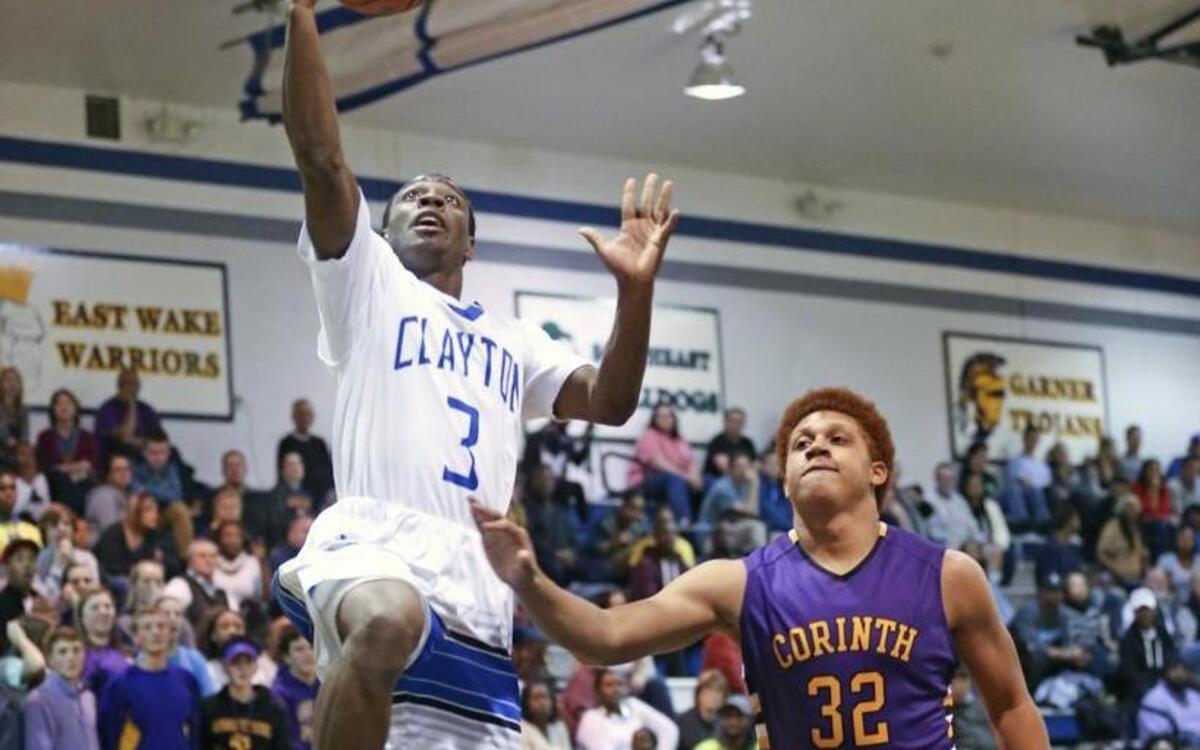 Clayton’s Tre Armstead (3) goes in for an easy layup as Corinth Holders' Khalil Bryant (32) trails the play. Coverage from the boys high school basketball game between the Clayton Comets and Corinth Holders Pirates played in Clayton, N.C. on January 5, 2016. Clayton defeated Corinth Holders 53-40.
