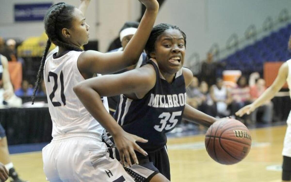 Millbrook’s Jaleesa Dillard (35) dribbles against the defense of Hillside's Jada Morgan (21) during the of The NCHSAA 4A East Finals girls basketball game, Millbrook against Hillside. Millbrook wins 58-51. Saturday, March 5, 2016. Crown Arena, Fayetteville, N.C, Damon Thomas.