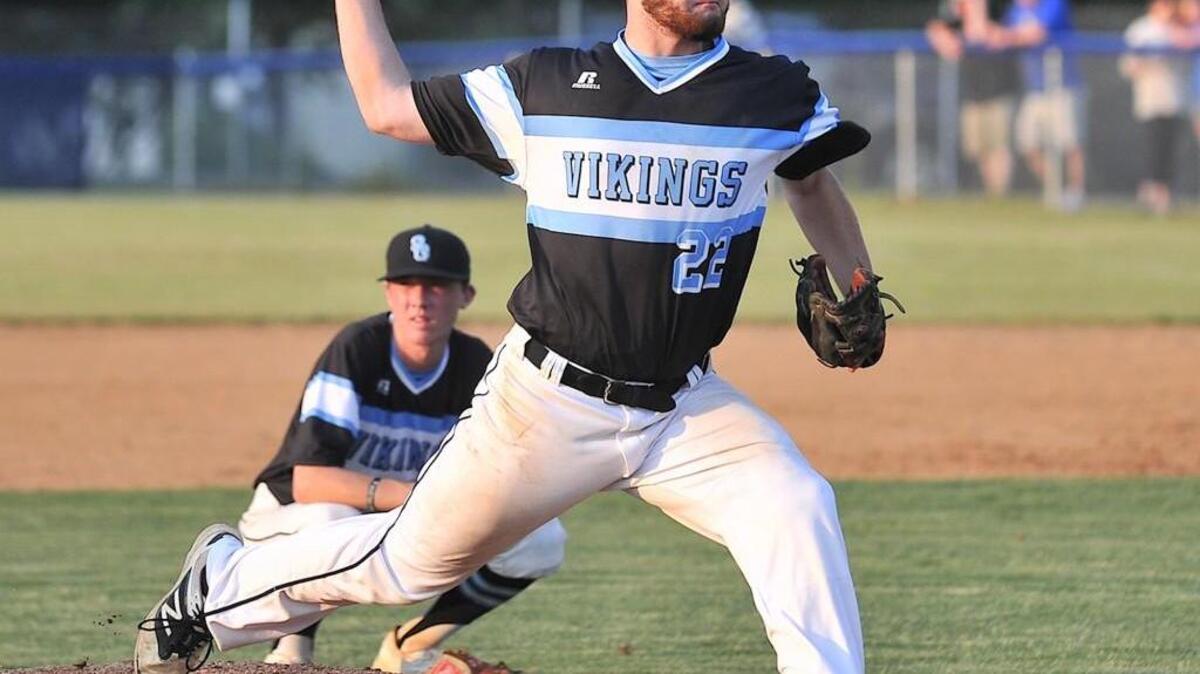 South Granville's Justin Brown (22) winds up his pitch in warm-ups during the seventh inning. The Edenton Holmes Aces took on the South Granville Vikings in the the N.C. High School Athletic Association 2A East Final at South Granville in Creedmoor, N.C. on May 26, 2015. South Granville won 4-3 and the Eastern Championship.