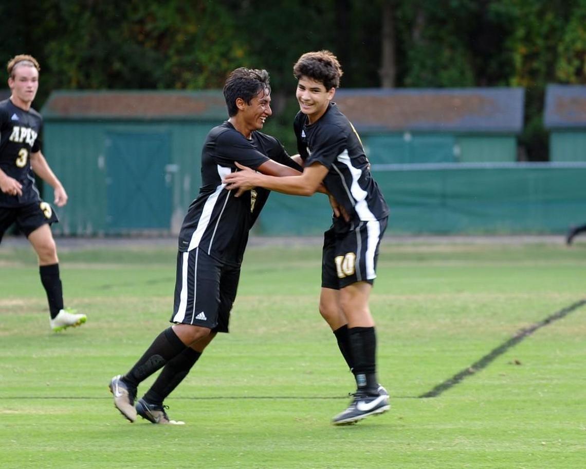 Apex's Juan Garcia (left) and Luc Madrid celebrate Madrid's goal during the soccer game against Cary, which was played in Cary on Wednesday, August 31, 2016. Apex won 4-3 in overtime.
