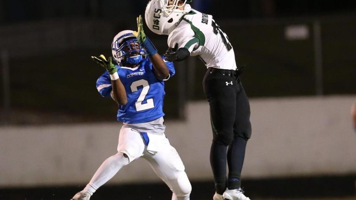 Southeast Raleigh's Naseem Robinson (25) defends and knocks the ball down Clayton's Macaleb Robertson (2) during the Clayton Comets high school football game with the Southeast Raleigh bulldogs high school on November 4, 2016, in Clayton , N.C.
