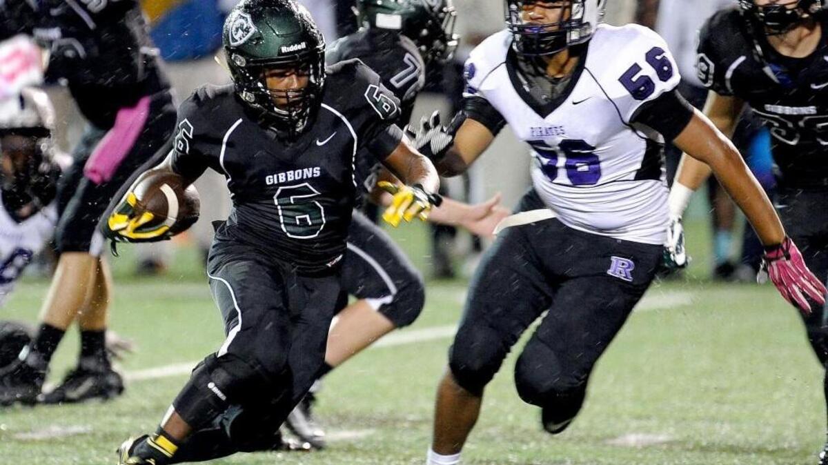 
Cardinal Gibbons' Dalen Spruill (6) is pursued by Riverside's Dejon Decruz (56) during their football game on Thursday, October 01, 2015 in Raleigh.
