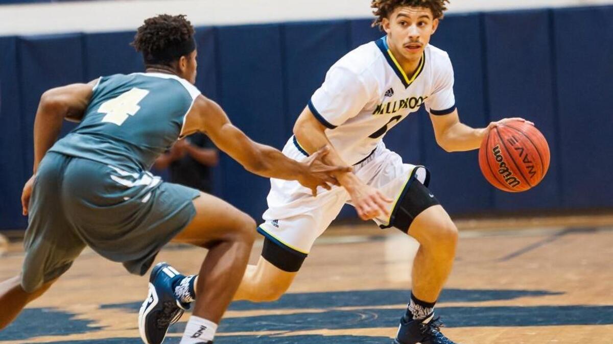 Millbrook’s JordanWhitfield (5) drives past Knightdale's Carnell Watkins (4) during a boys basketball game on Thursday, November 19, 2015, in Raleigh, N.C. Millbrook Wildcats won 72-67.