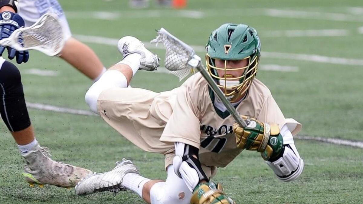Cardinal Gibbons' Anthony Digirolamo hangs onto the ball after running into a Hoggard player during the boys lacrosse game, which was played on Tuesday, May 17, 2016 in Raleigh. Cardinal Gibbons won 13-6.
