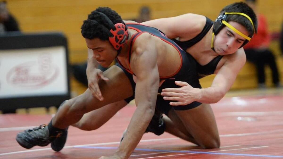 Anthony Castellano, right, of Chapel Hill wrestles Mahari Rouse, left, of Southern at 160 lbs. during the dual team match between the Chapel Hill Tigers and the Southern Spartans in Durham, N.C. on Thursday, January 21, 2016. Chapel Hill won 69-10.