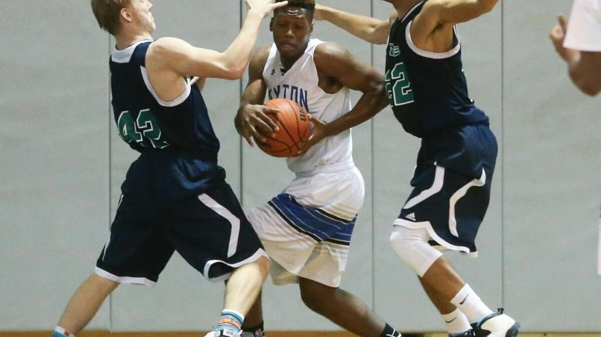Clayton’s Darius Stevens (14) is swarmed by Leesville Road’s Patrick Rice (42) and Jonathan Mebane (22) as he tries go to the basket.
