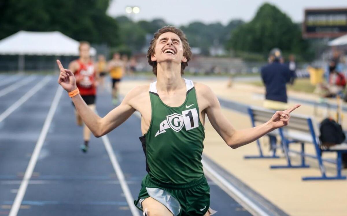 Cardinal Gibbons' Connor Lane celebrates as he crosses the finish line and wins the 3200 meter run with a new state record of 8:59.90 during the NCHSAA 2A and 4A track and field state championships in Greensboro on Friday, May 19, 2017. Lane also won the 1600 meter run.