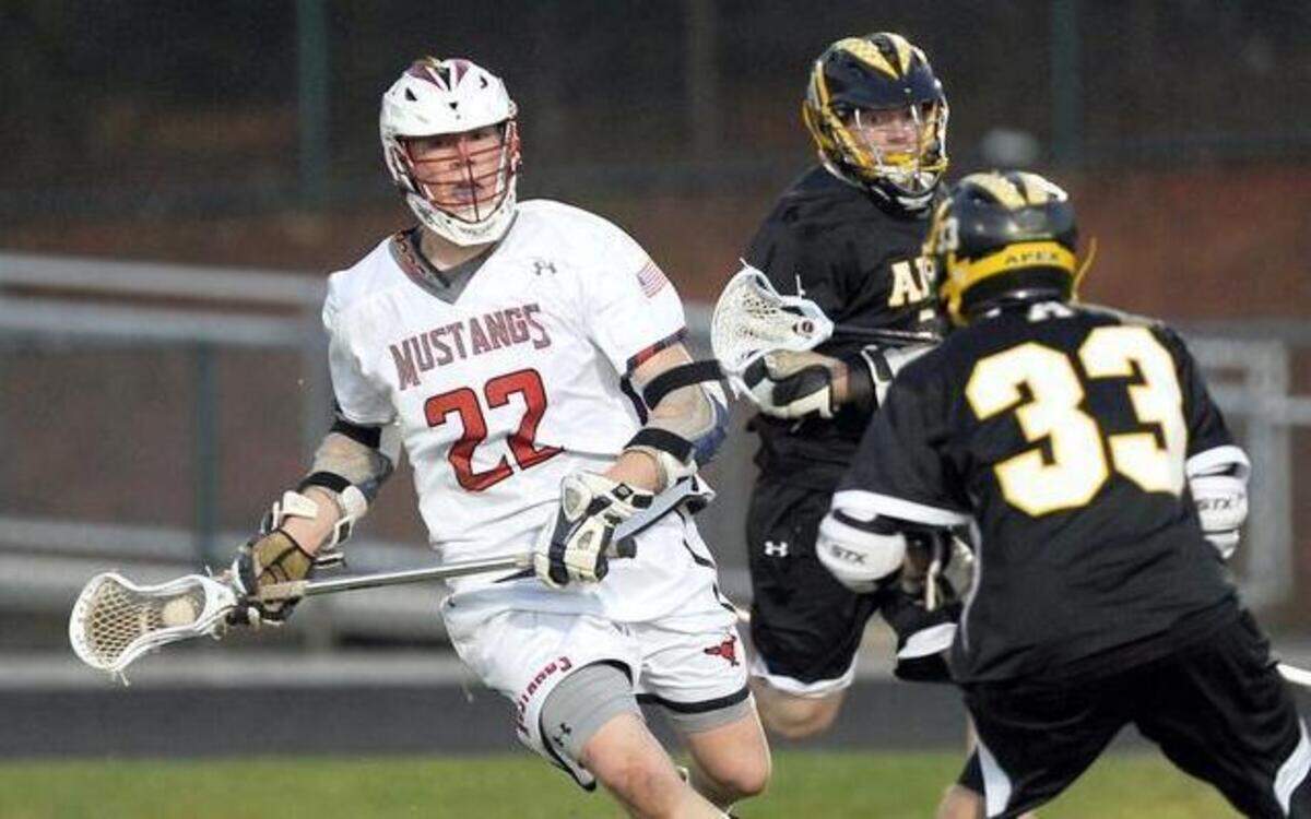 
Middle Creek's Ryan Robley (22) is challenged by Apex's Brandon Freer  during the boys lacrosse game on Tuesday in Apex. Middle Creek won 16-6.
