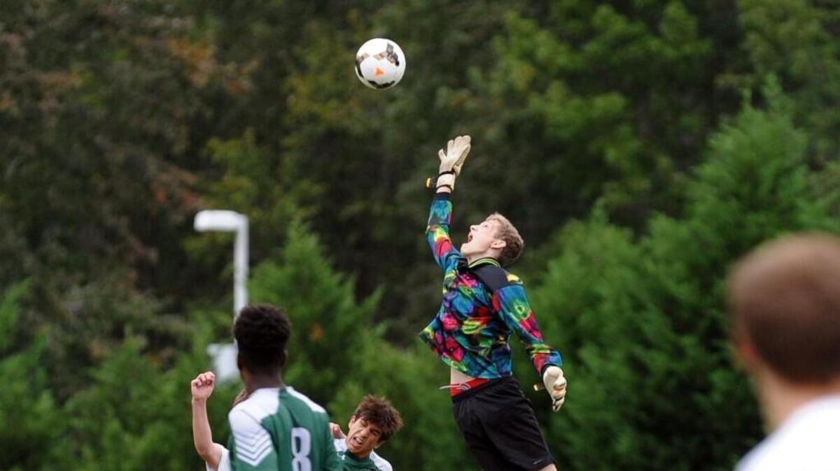 Research Triangle goalkeeper Chandler Frye makes a save during the boys soccer game against Raleigh Charter, which was played in Cary on Wednesday, October 5, 2016. Raleigh Charter won 5-1.