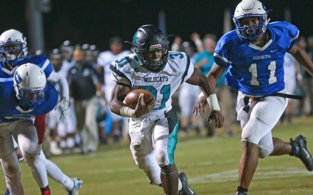 West Johnston's Tony Mack (31) cuts inside of Clayton defender Romeo Stancil (6) on his way to a 23 yard touchdown to put the Wildcats up 13-0 with 6:23 left in the 1st quarter. Coverage from the prep football game between the Clayton Comets and West Johnston Wildcats played in Clayton, N.C. on Friday, October 21, 2016. West Johnston defeated Clayton 48-0.