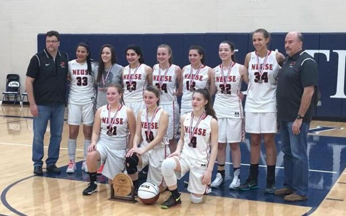 The Neuse Christian Lions girls basketball team poses with the NCISAA 1A runner-up trophy after falling to Trinity Christian in the state title game on Feb. 25, 2017.