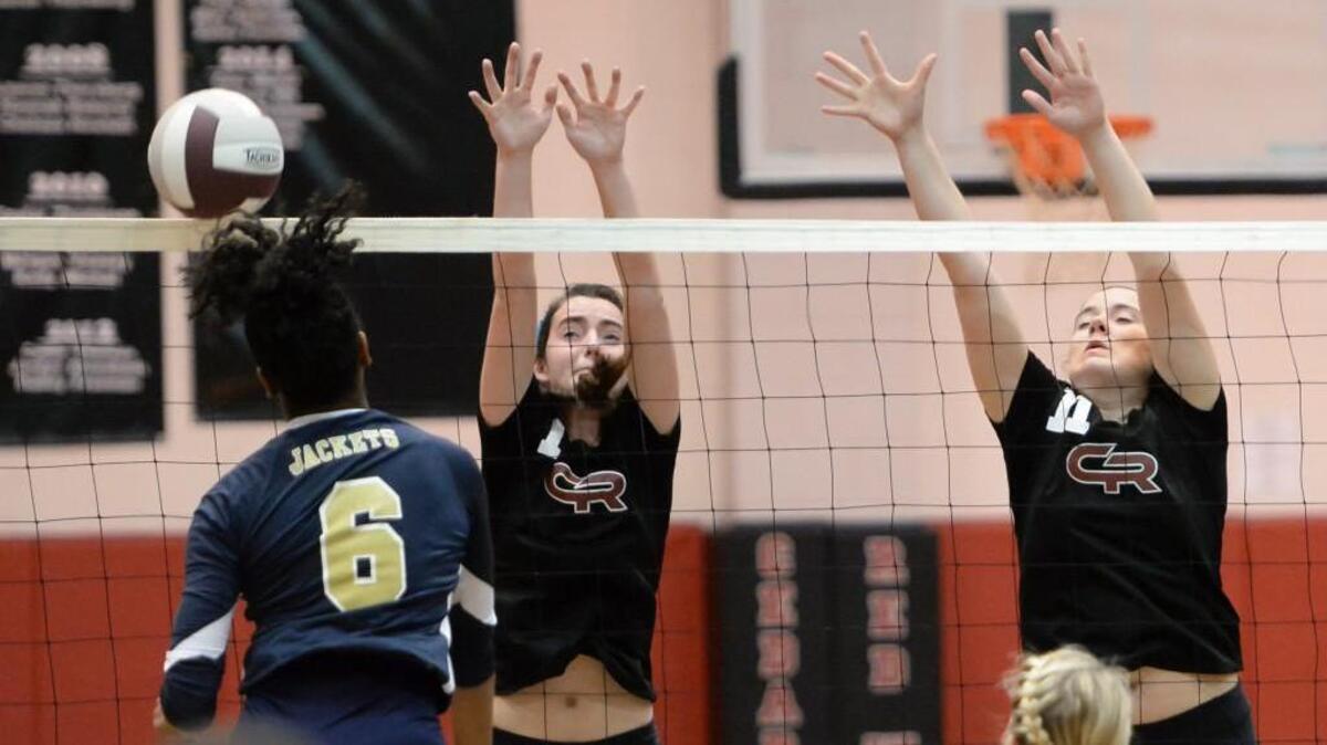 Liliana Henry, center, and Kayla Robinette, right, of Cedar Ridge attempt to block a shot from Khaira Bolden (6) of Lee County. The Cedar Ridge Red Wolves played the Lee County Yellow Jackets in Hillsborough, N.C. on Saturday, October 31, 2015. Cedar Ridge won 3-0.