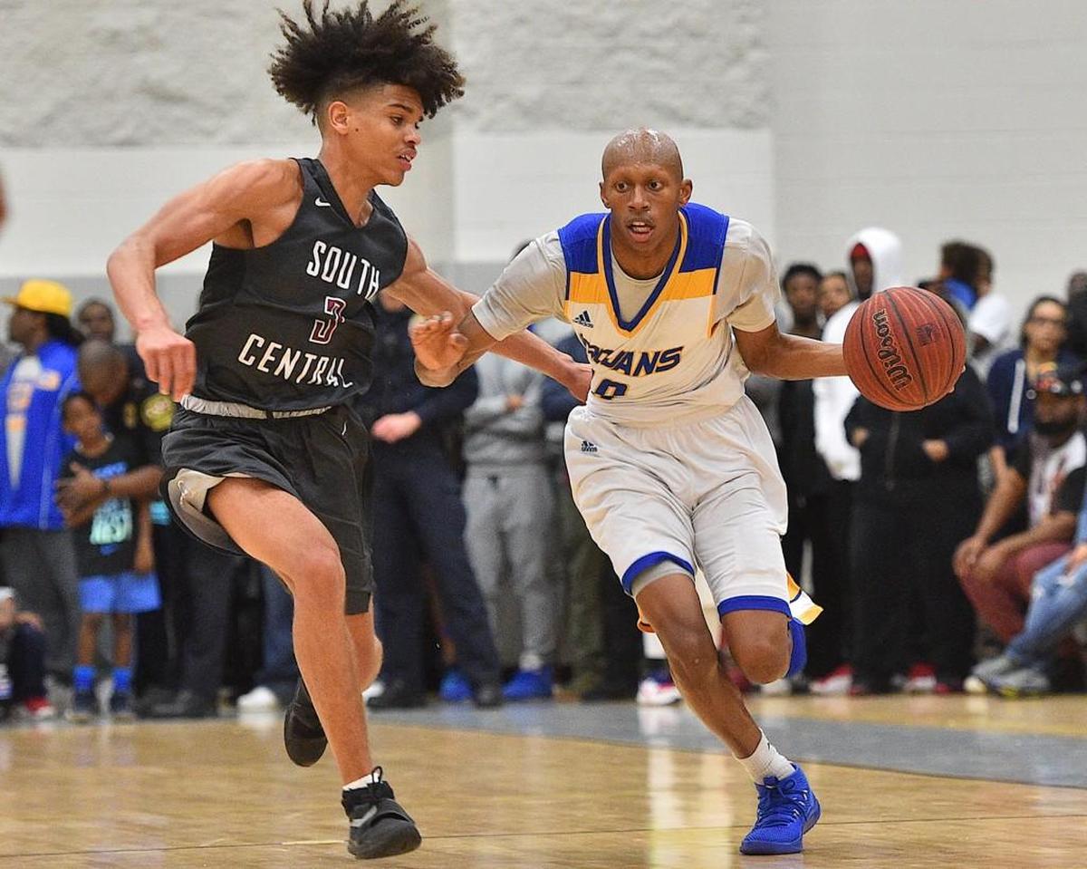Garner's Marque Maultsby (10) drives down court against South Central's Shykeim Phillips (3). The South Central Falcons took on the Garner Trojans in the fourth round of the NCHSAA4A boys basketball play offs in Garner, N.C. on February 27, 2018. South Central edges Garner 69-67.