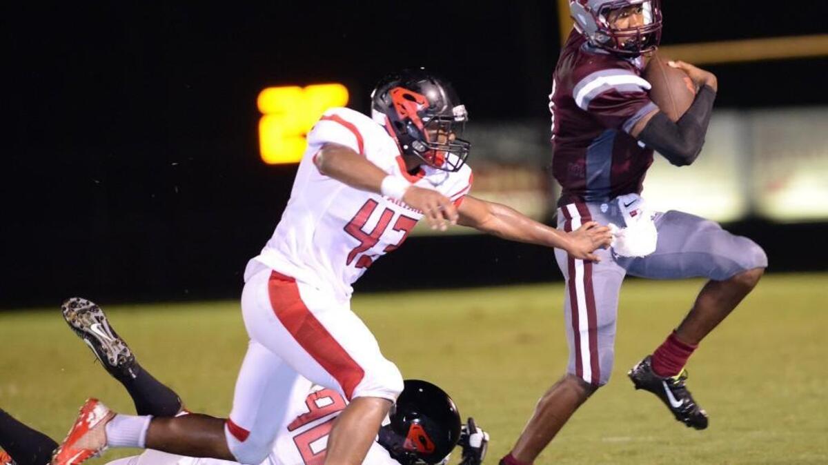 
Matt Mckay, right, of Wakefield moves the ball against Roosevelt Holding (43) and Ezekiel Jennette (90) of Southern. The Wakefield Wolverines played the Southern Spartans in Raleigh, N.C. on Friday, September 11, 2015.
