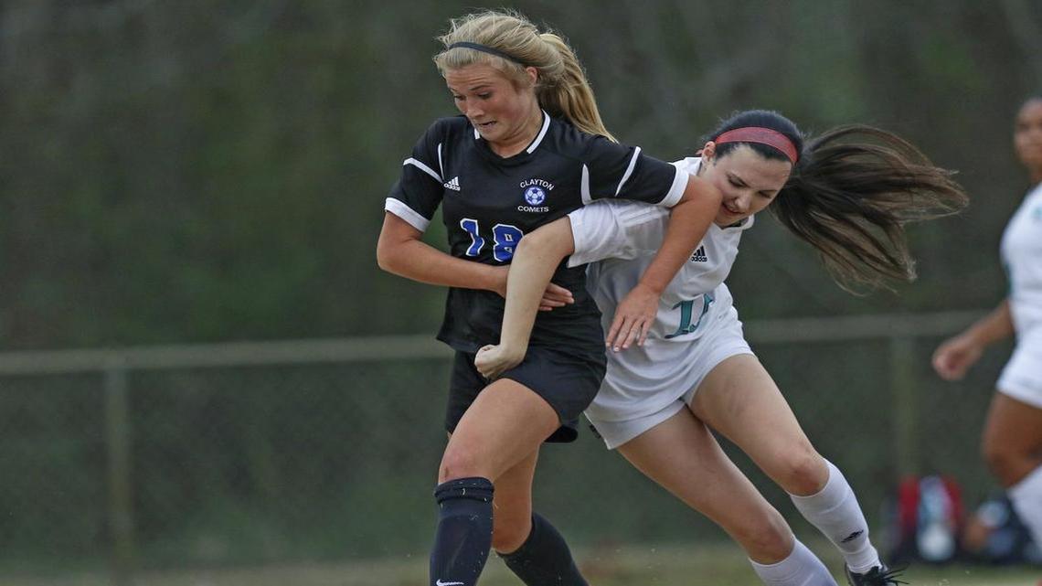Clayton's Emery Biggs (18) and West Johnston's Amanda Lillie (18) fight to gain control of a loose ball. Coverage from the Four Oaks Bank Cup Girls Soccer Tournament championship game between the Clayton Comets and the West Johnston Wildcats played in Smithfield, N.C. on Wednesday, March 1, 2017. Clayton defeated West Johnston 4-0 to win the championship.