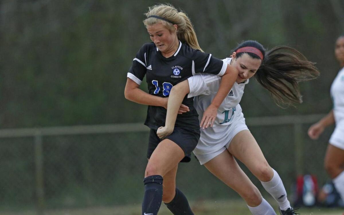 Clayton's Emery Biggs (18) and West Johnston's Amanda Lillie (18) fight to gain control of a loose ball. Coverage from the Four Oaks Bank Cup Girls Soccer Tournament championship game between the Clayton Comets and the West Johnston Wildcats played in Smithfield, N.C. on Wednesday, March 1, 2017. Clayton defeated West Johnston 4-0 to win the championship.