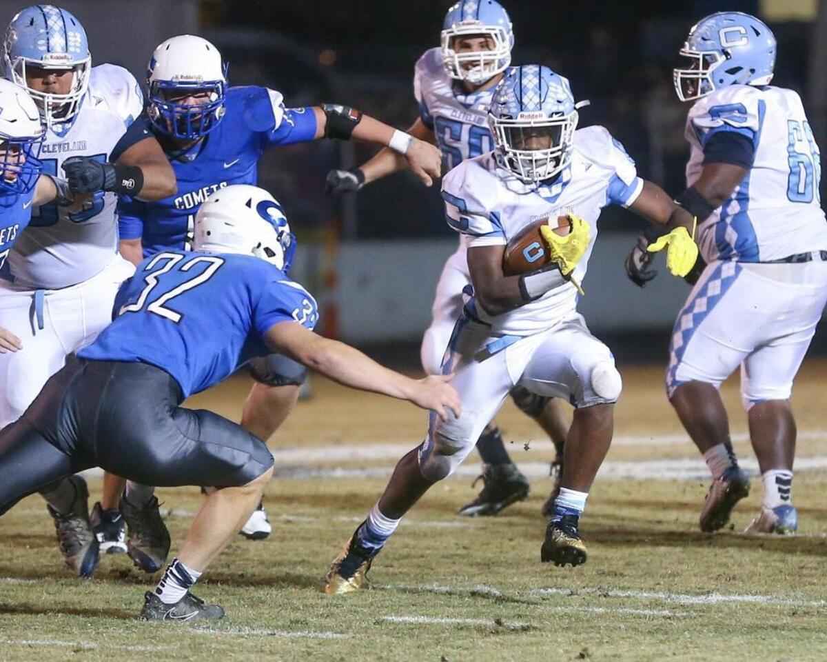 Cleveland running back Tyson Dew (4) makes a move outside to get around Clayton defender Noah Williams (32). Coverage from the second round of the NCHSAA 3AA football playoffs between the Clayton High Comets and the Cleveland High Rams played in Clayton, N.C. on Friday, November 17, 2017.