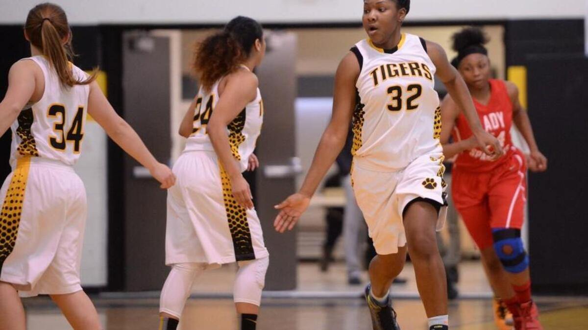 Ti'Mia Chaplin (32) of Chapel Hill celebrates with her teammate Anna Grace Kelley (34) after scoring a basket. The Chapel Hill Tigers played the Southern Spartans in a girls basketball game that took place in Chapel Hill, N.C. on Tuesday, February 9, 2016. Chapel Hill won 60-56.