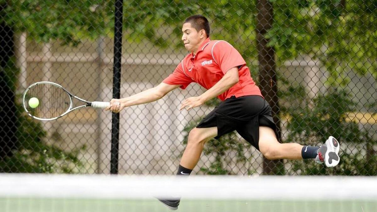 North Johnston’s Johnathan Gonzales runs down a serve during Wednesday’s 2A eastern regional championship match.