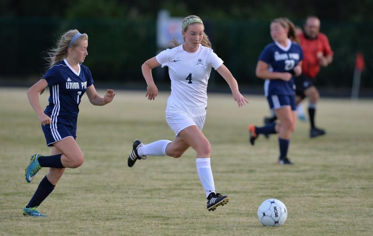 Laurynn Ansted (4) of Southern Lee breaks through the Vikings' defense, Allyson Gailey (7) and Kelsey Blatz, right, of Union Pines to score the first goal for the Cavaliers. The Southern Lee Cavaliers played the Union Pines Vikings in a girls soccer game that took place in Sanford, N.C. on Wednesday, May 3 2017. Southern Lee won 2-0.
