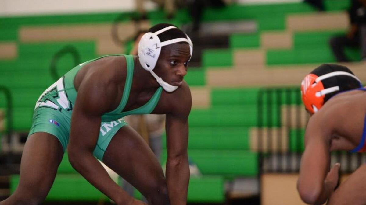 Kollin Wade, left, of Cary wrestles against Solomon Cornish, right, of Athens Drive at 145 lbs. Cary Imps hosted a wrestling match against the Athens Drive Jaguars in Cary, N.C. on Wednesday, January 28, 2015. Cary won 55-21.
