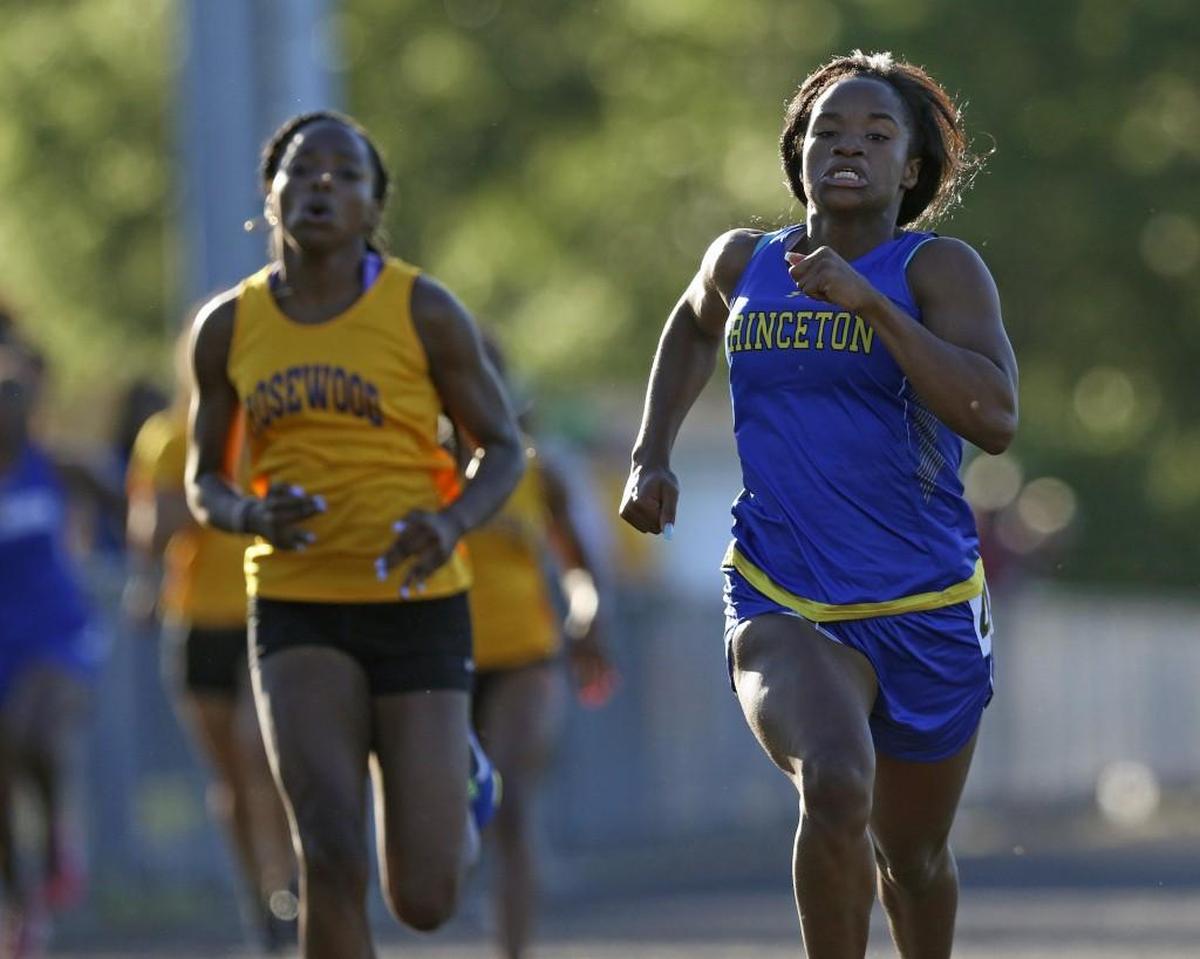 Princeton's Shamonda Bell leads Rosewood's Miyah McCall down the backstretch. Bell hold on to win the Girls 200 Meter dash championship. Coverage from Carolina 1A Conference Track and Field championships held in Princeton, N.C. on Wednesday, May 3, 2017. The Hobbton High girls and the Rosewood High boys won conference championships.