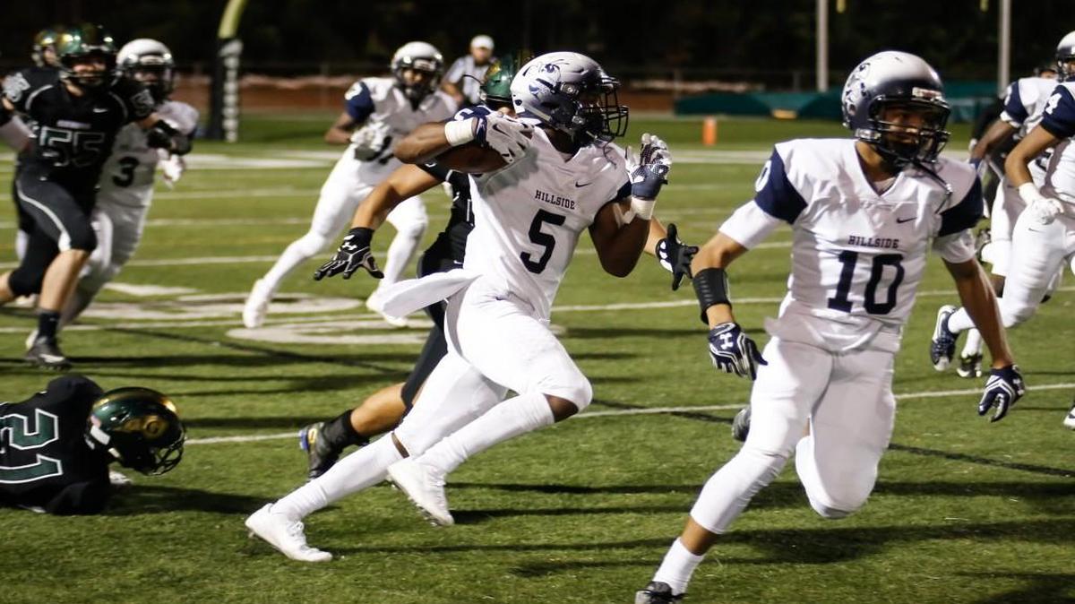 Hillside back Jamal Currie-Elliott (5) returns a kickoff for a touchdown in the final few seconds of Durham Hillside's football game at Cardinal Gibbons on Thursday, October 6, 2016. Durham Hillside won the game 41-35.