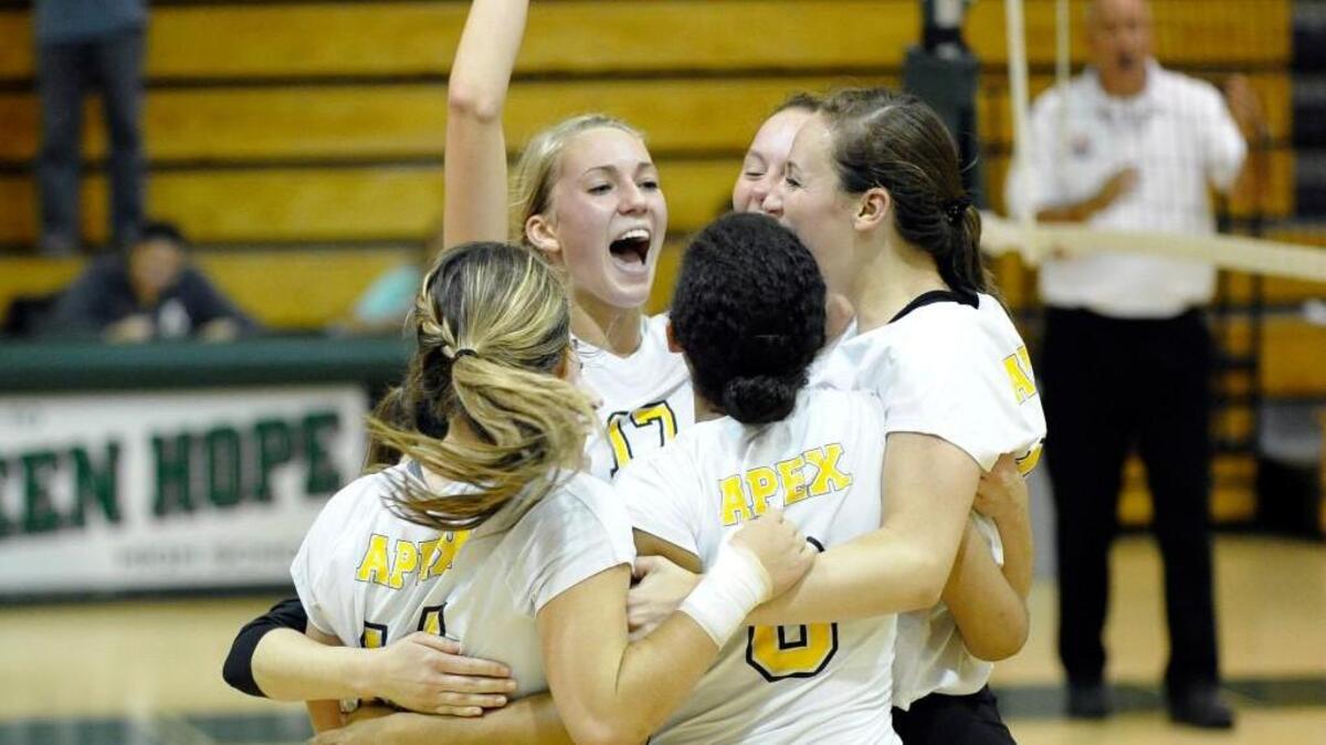 
Apex’s Abigail Veit, center, celebrates a win against Green Hope in the second round of the NCHSAA 4A playoffs on Tuesday, October 21, 2014. Apex won 3-0.
