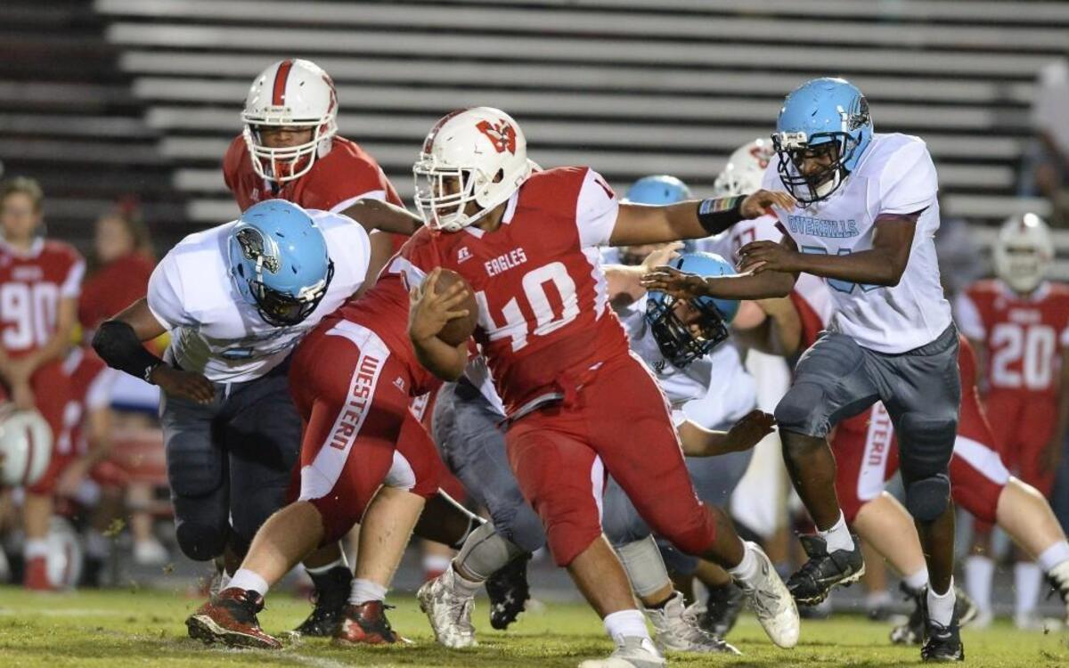 Gordon Thomas (40) of Western Harnett carries the ball against the pursuit of D'shaun Mcfarlane, right, of Overhills. The Western Harnett Eagles played the Overhills Jaguars in a football game that took place in Lillington, N.C. on Thursday, August 31 2017. Overhills won 48-28.