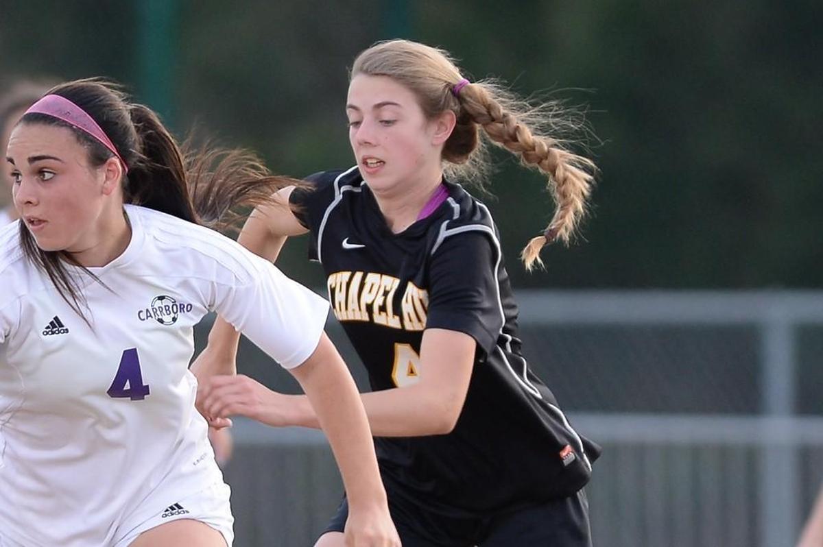 Alex Kerr, right, of Chapel Hill tries to pressure a Carrboro player. The Carrboro Jaguars played the Chapel Hill Tigers in Carrboro, N.C. on Wednesday, March 16, 2016. Chapel Hill won 2-1.