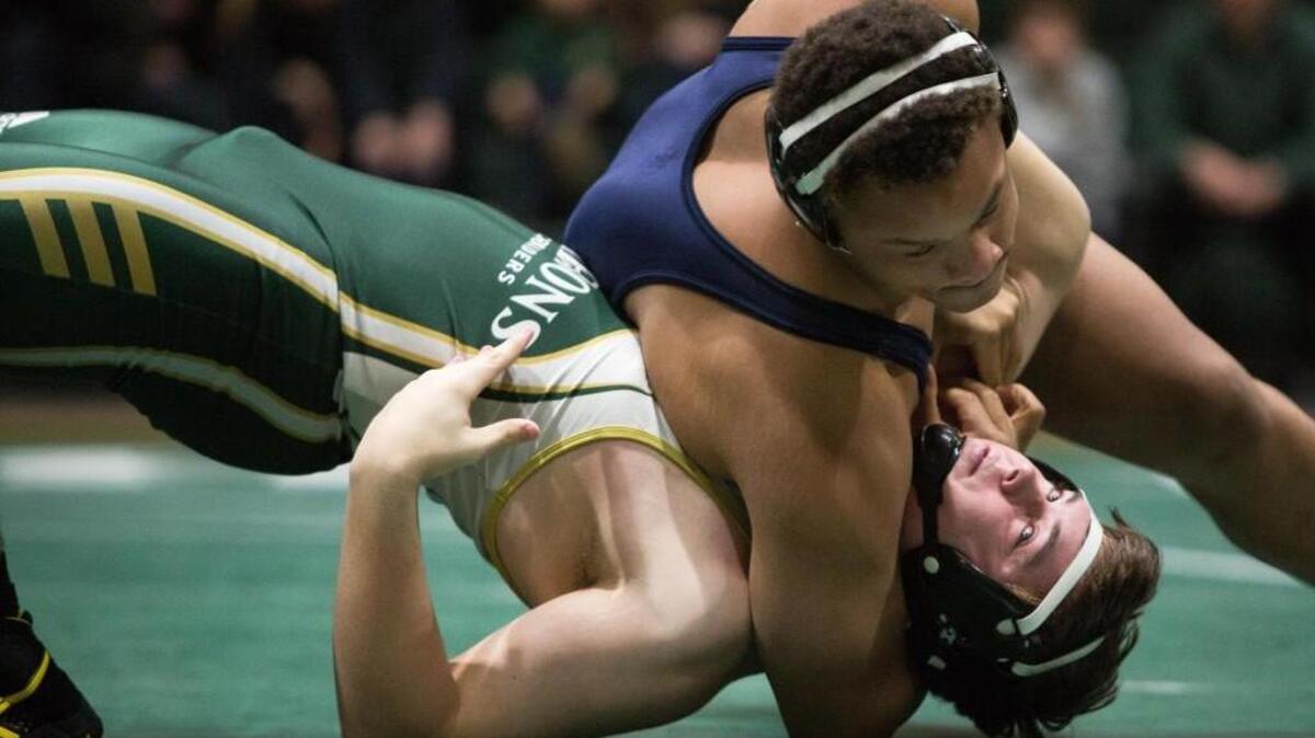 Northern Durham's Demazio Samuel (top) holds Cardinal Gibbons' Jackson Hawkins (bottom) during a high school wrestling match in Raleigh, N.C. on Thursday, Jan. 28, 2016.